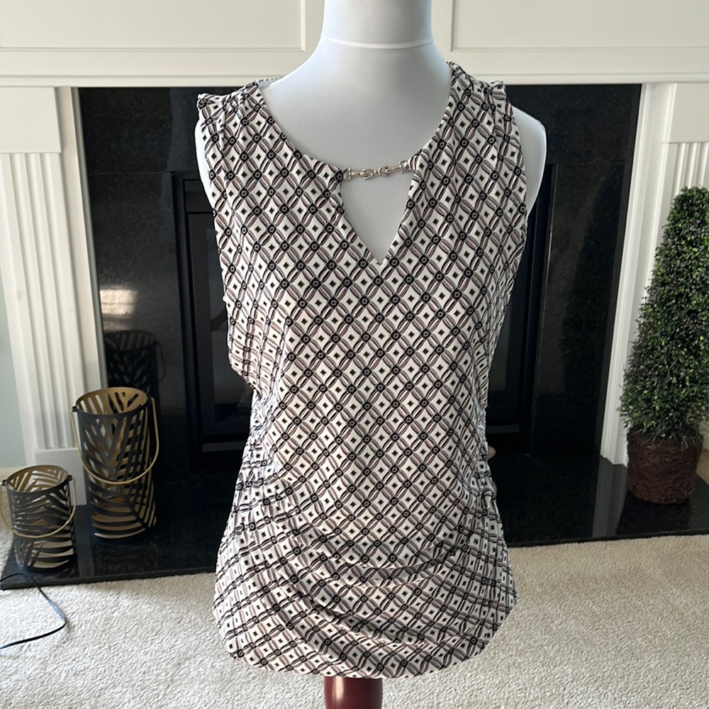 Sleeveless top. Business or night out on the town. Mint condition worn once.